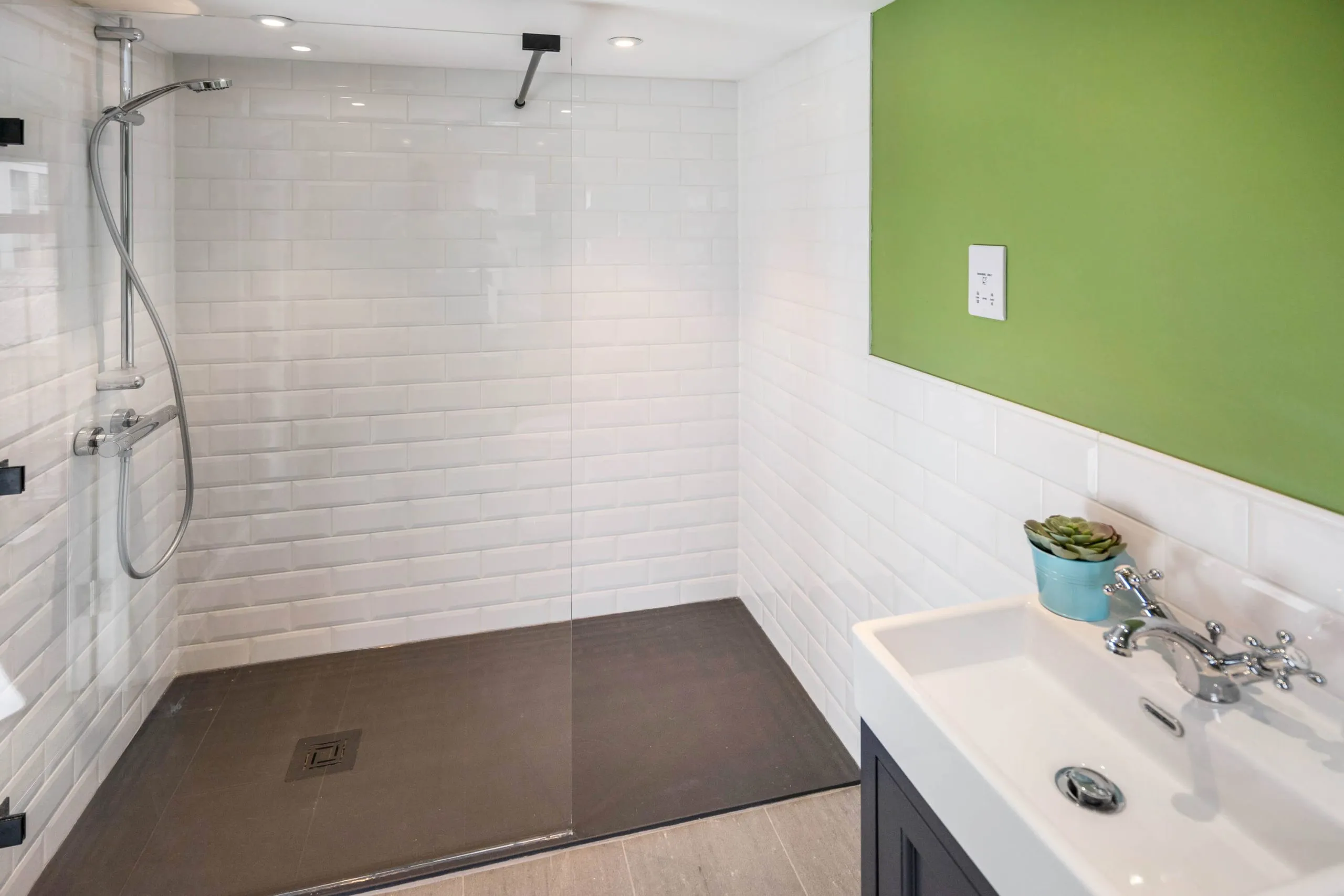 Completed walk-in shower with white tiling by Cube Tiling & Bathrooms