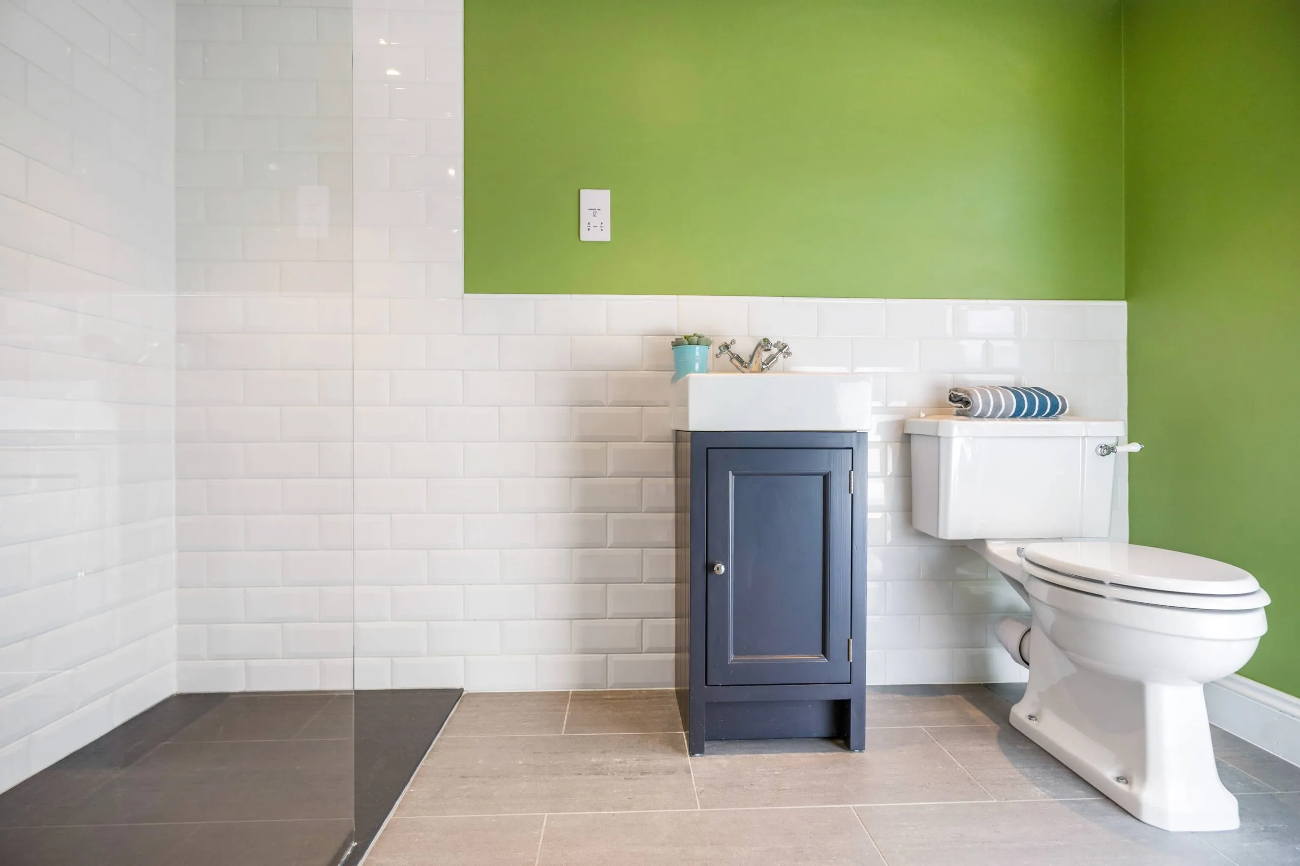 Completed bathroom with bath and tiled walls by Cube Tiling & Bathrooms