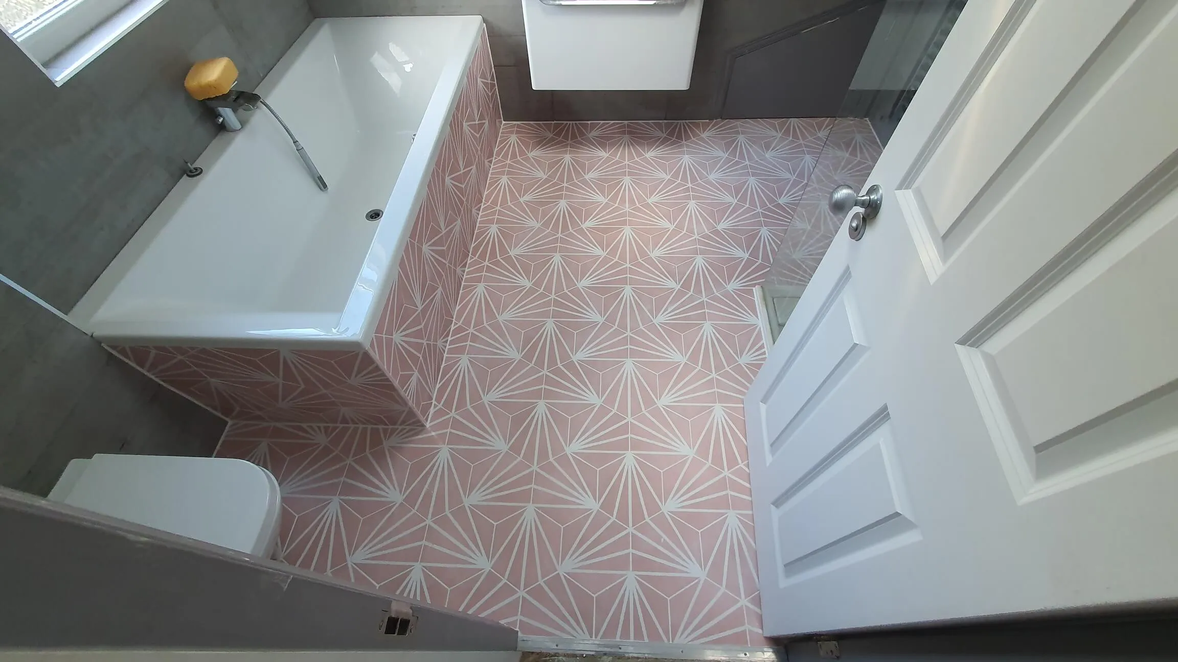 Bathroom installation in progress toward a finished tiled room