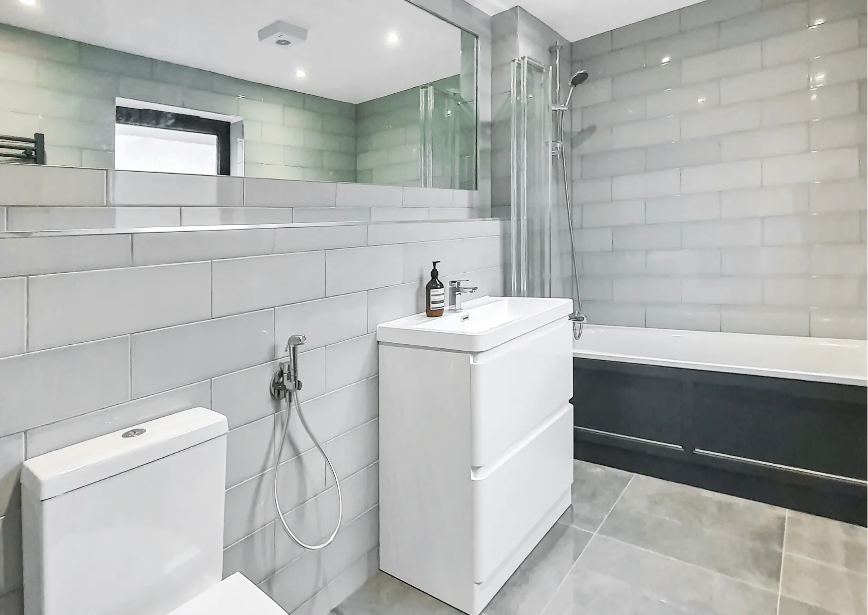 Completed bathroom with white tiling by Cube Tiling & Bathrooms