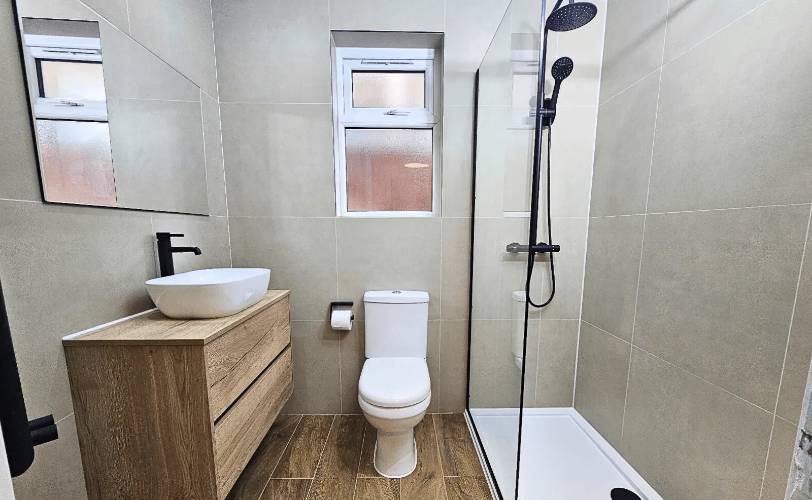 Completed bathroom with vanity unit and shower enclosure by Cube Tiling & Bathrooms